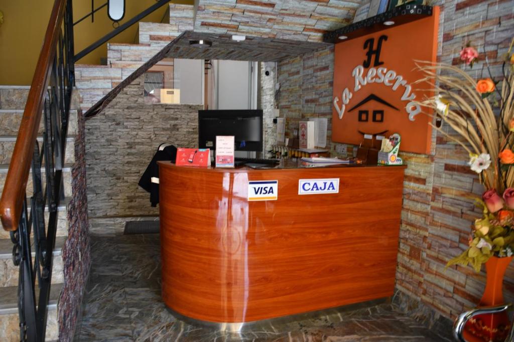 a bar in a restaurant with a brick wall at Hotel La Reserva INN in Ayacucho
