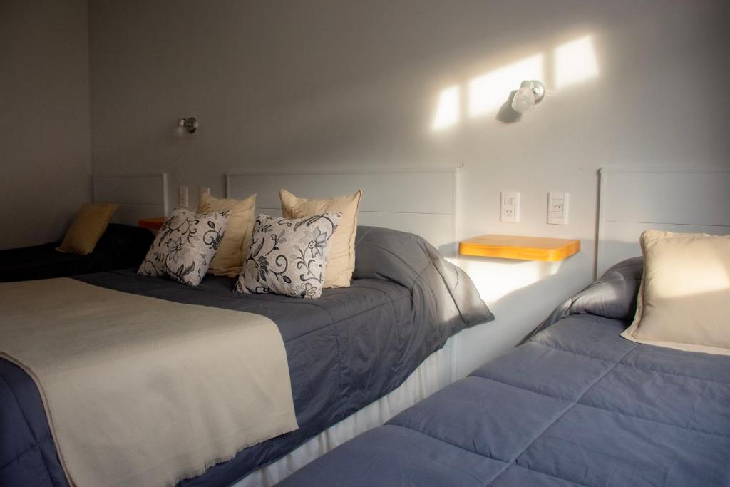 a bedroom with a bed and two pillows at Sitios del Sol 1 in General Acha