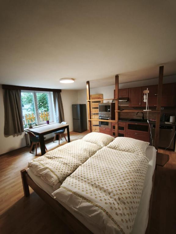 a bedroom with a bed and a table in it at Guest House Hartenberg in Sokolov