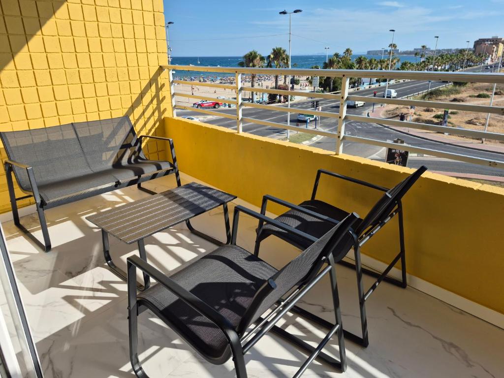 a group of chairs and tables on a balcony at Playa Los Náufragos Torrevieja in Torrevieja