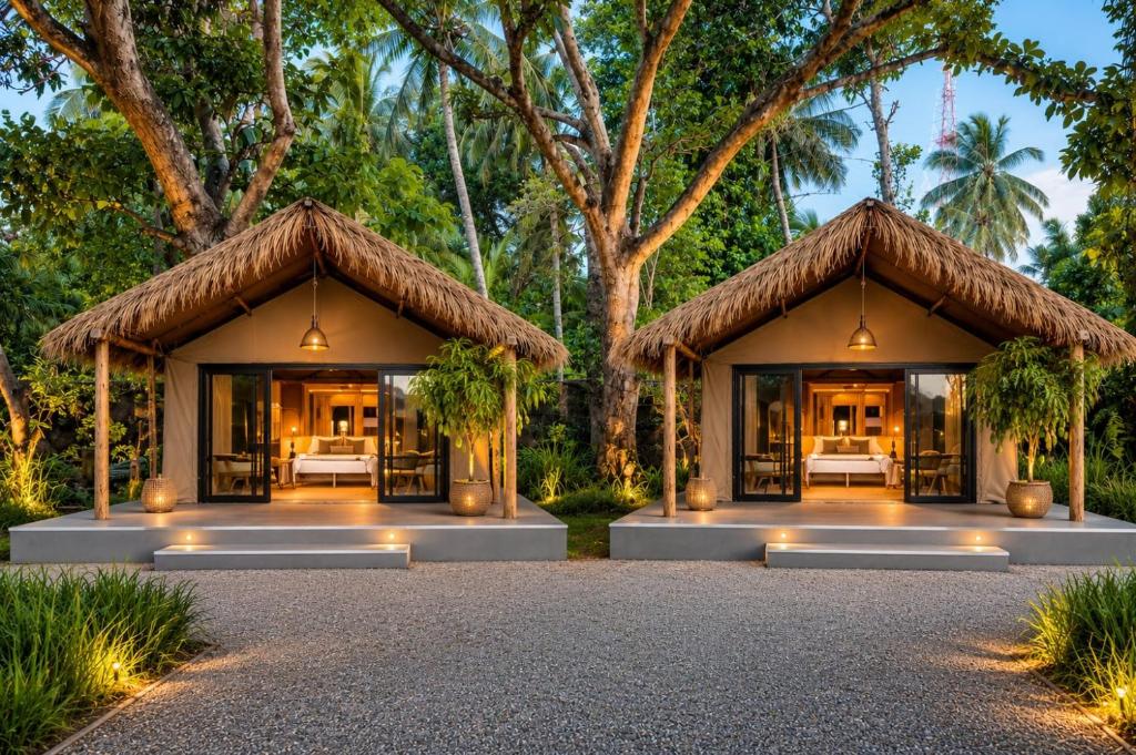 a villa with a resort with beds and trees at EMERALD HAVEN Safari Glamping in Udawalawe