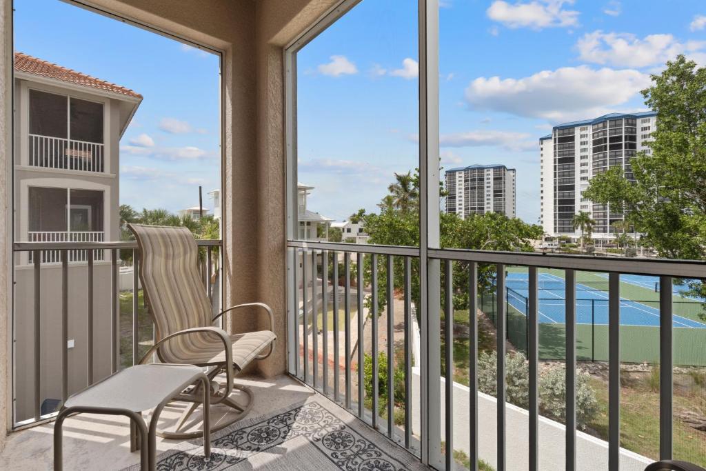 a balcony with a chair and a view of the ocean at White Cap Condo B201 by Sun Palace Vacations in Fort Myers Beach