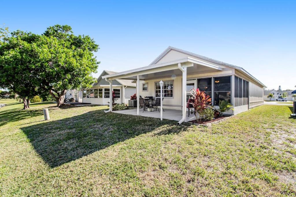 a white house with a grass yard at Bella Villa in Bradenton