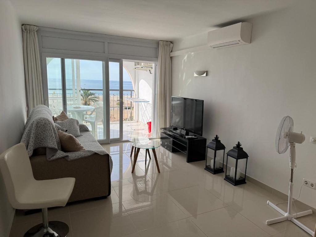 a living room with a couch and a television at AwayDays - 72 - Ocean View Studio in Empuriabrava