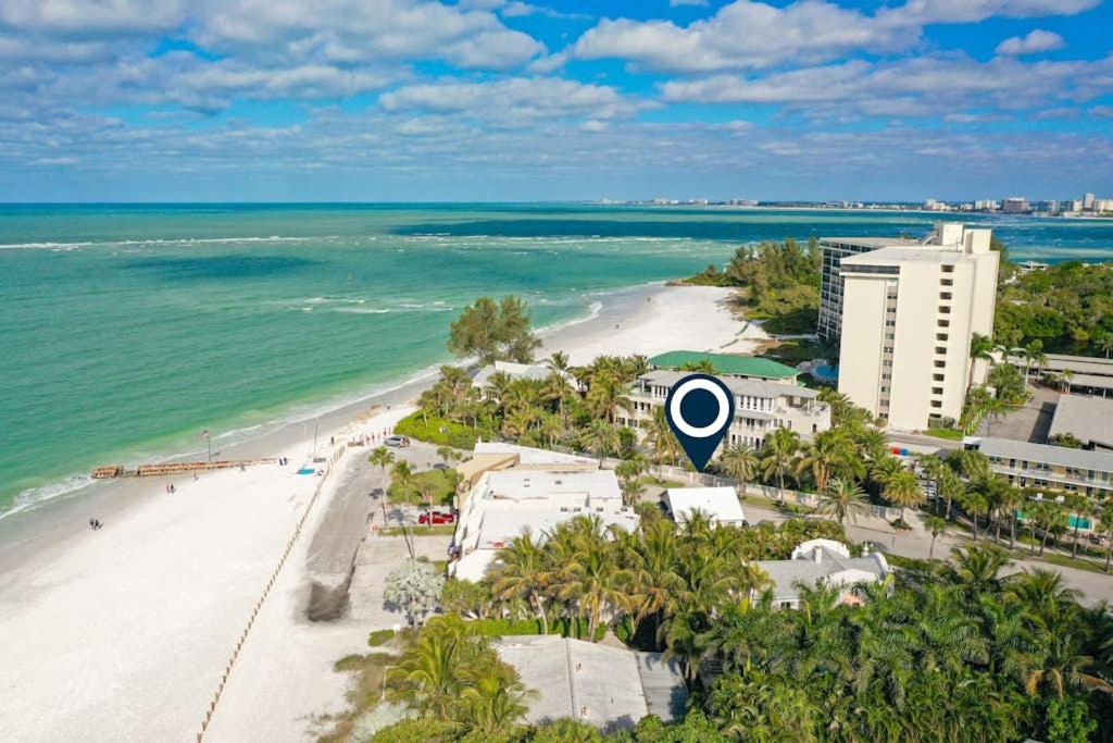 an aerial view of a beach with a building and the ocean at Parrot Beach Cottages Suite #4 in Siesta Key