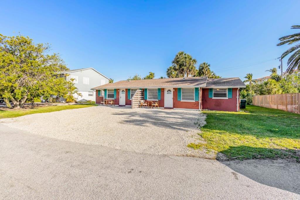 a house with a driveway in front of it at Holmes Beach Bungalow - B in Holmes Beach