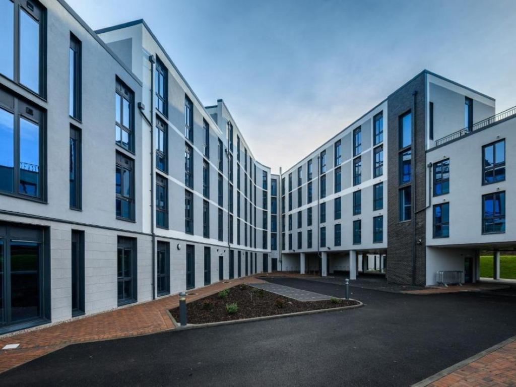 an external view of a building with a parking lot at ABeleven in Aberdeen