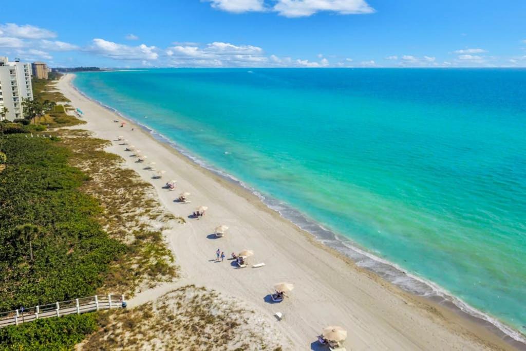 an aerial view of a beach with umbrellas and the ocean at Paradise Time Hideaway in Longboat Key