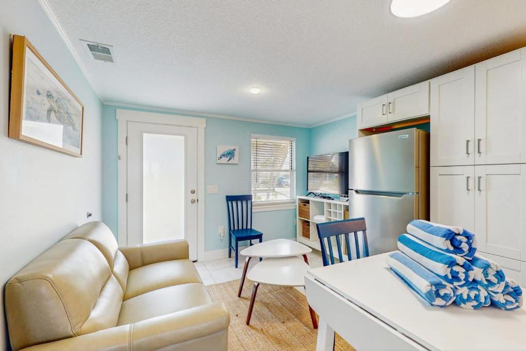 a living room with a couch and a kitchen at Playa Casanas North in Holmes Beach