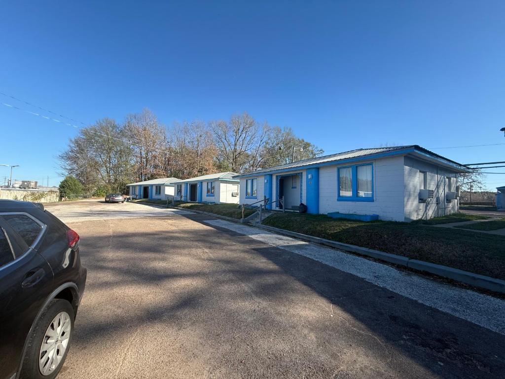a car parked in front of a row of houses at Terrace Motel in Natchez
