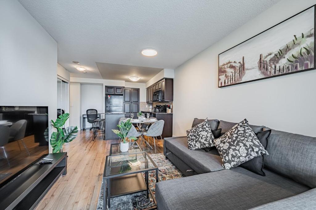 a living room with a couch and a table at Mississauga Downtown Condos in Mississauga