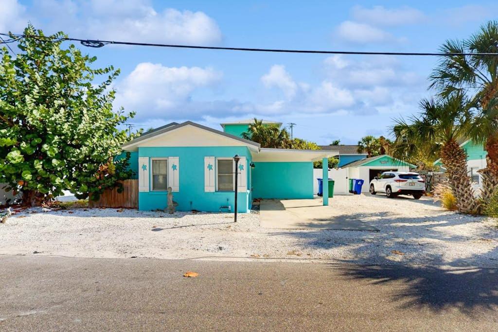 a blue house with a car parked in front of it at Sea's The Day in Anna Maria