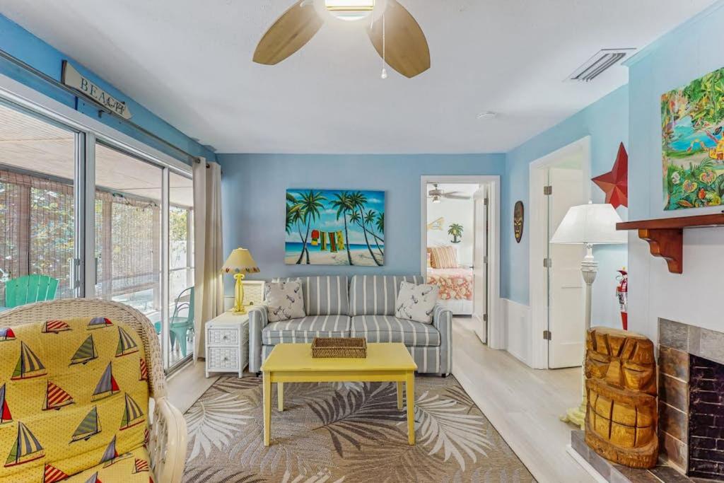 a living room with a couch and a table at 21 Palms on Anna Maria in Anna Maria
