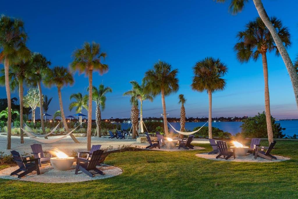 a group of chairs and palm trees on the beach at Carlton Arms View B1 # A in Bradenton