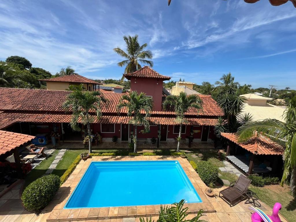 an image of a house with a swimming pool at GuestHouse Casa da Aroeira in Búzios