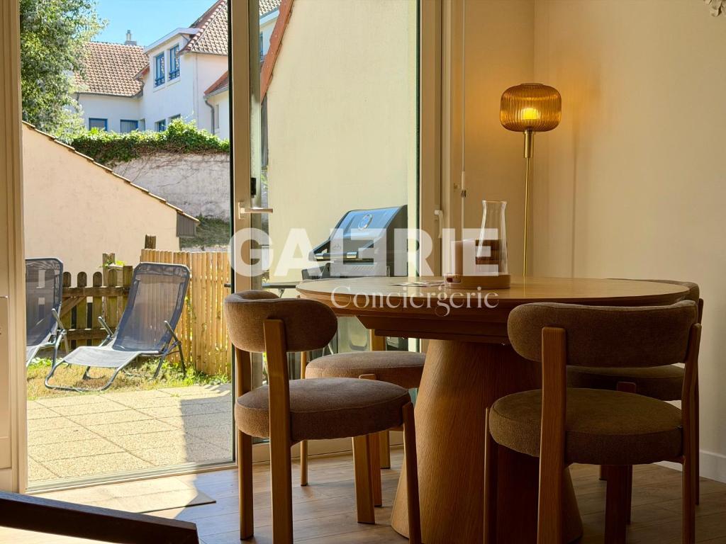 a dining room with a table and chairs and a window at GC - Les Flots in Wissant