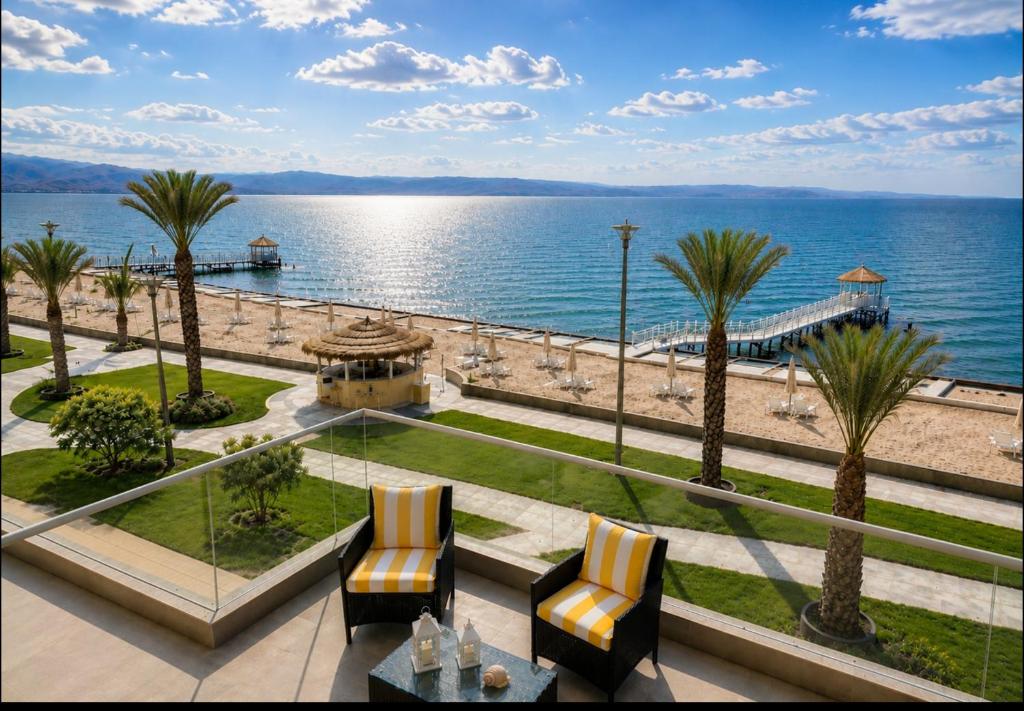 a view of the ocean from a resort with chairs at Ocean View Apartment Beach Pools Pier & Lift in Paracas