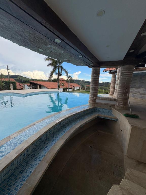 a swimming pool with a large swimming pool at Finca La Yeye in Puentetierra