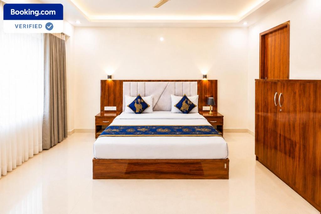 a bedroom with a large bed in a room at Premium Radhe Dham Hotel & Restaurant - Fully AC - Only 5 Min Drive to Prem Mandir, Newly Build in Vrindāvan