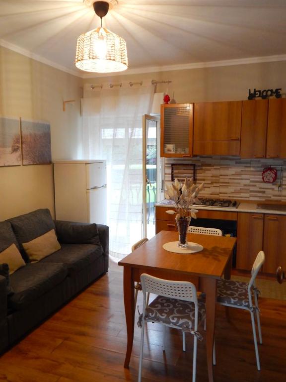 a living room with a couch and a table with chairs at Suli e Sali Apartment in Calatabiano