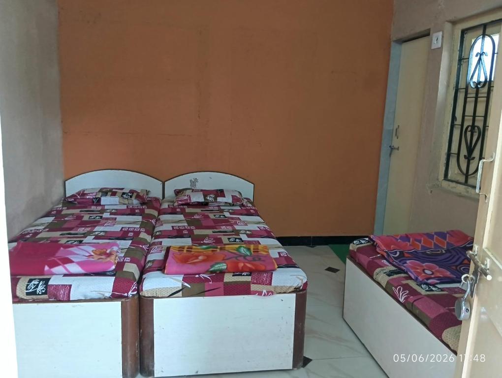 a bedroom with two beds in a room at Parshotam Home Stay in Dwarka