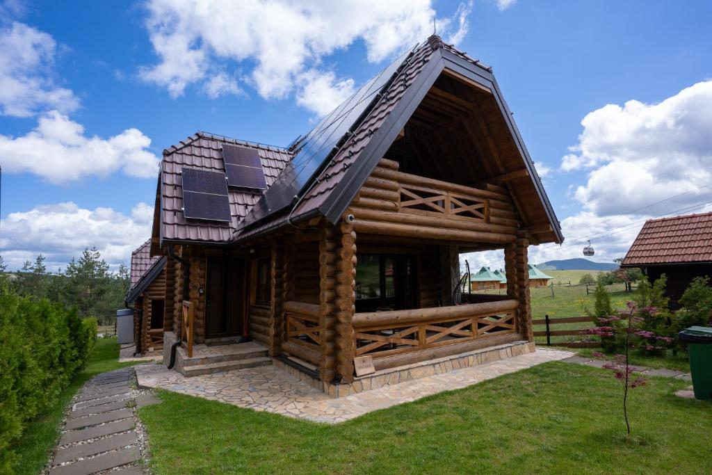 a large log cabin with a pitched roof at Aurum Cabins in Zlatibor
