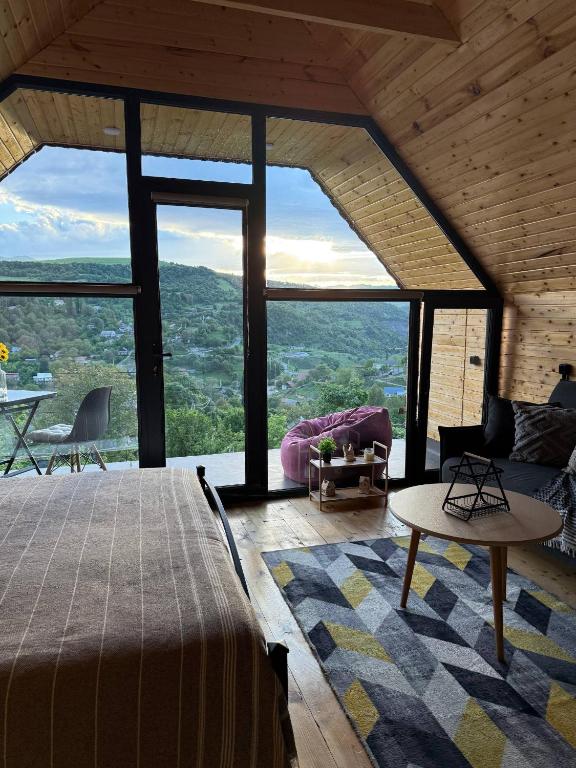 a bedroom with a bed and a large window at Debed View in Debed