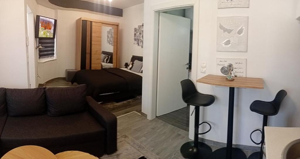 a living room with a couch and a table at Studio apartman Relax in Sanski most