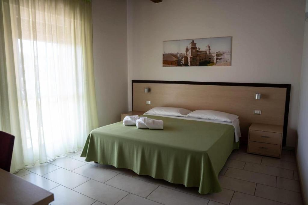 a bedroom with a bed with two towels on it at Alloggio Le Macine in Ferrara