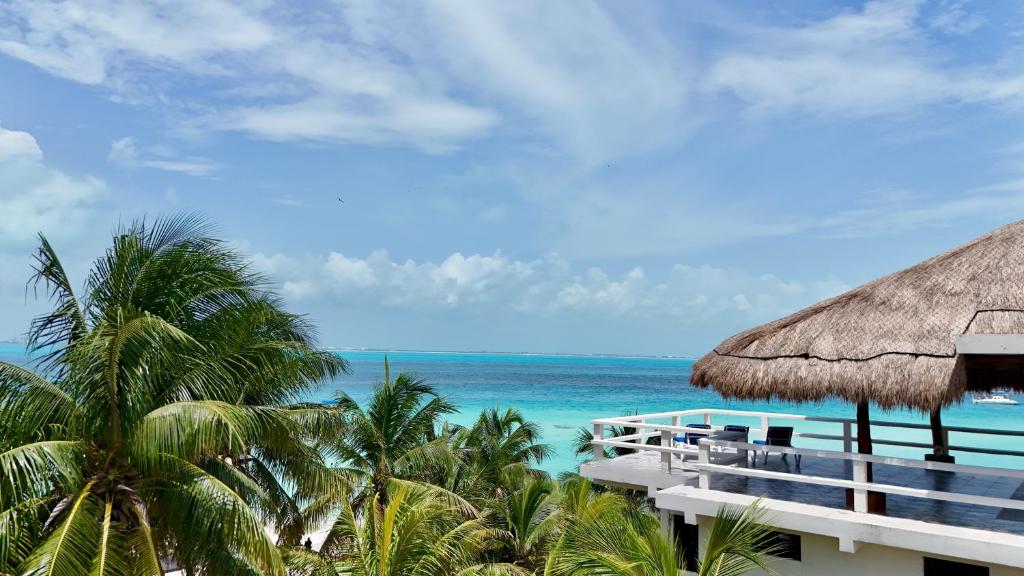 a view of the ocean from the balcony of a resort at Charly Beach Hotel in Isla Mujeres