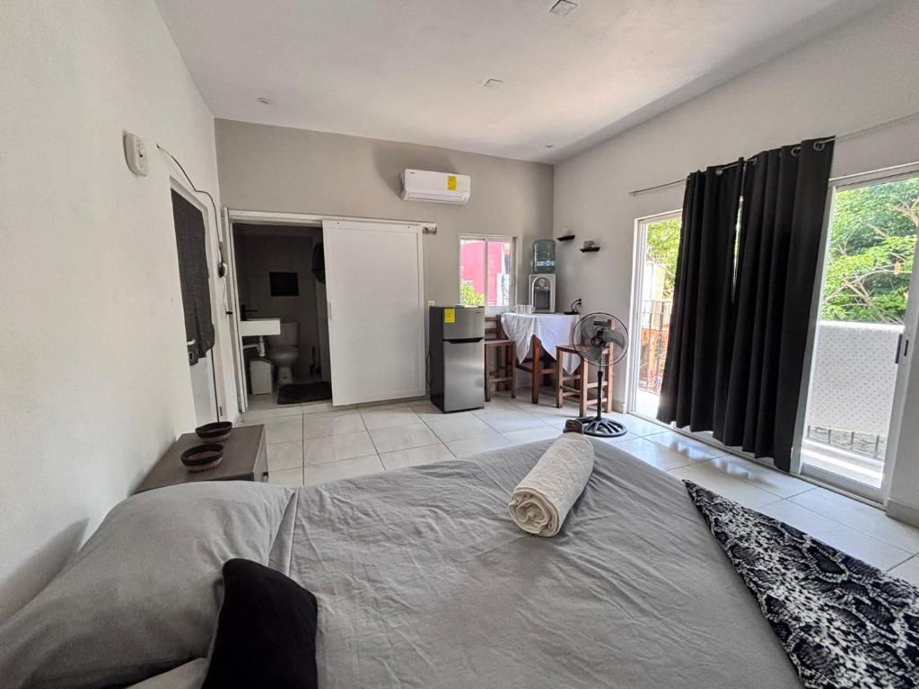 a bedroom with a bed and a living room at La Isla Studio - Quimixto in Qumiste