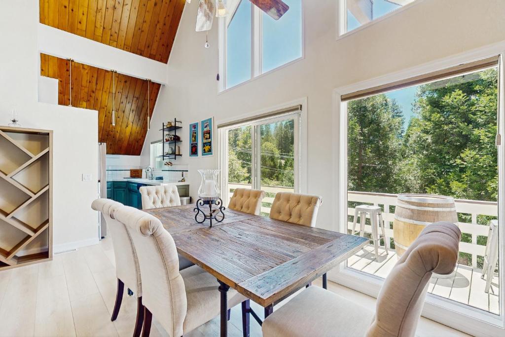 a dining room with a wooden table and chairs at The Fairway Chalet in Lake Arrowhead