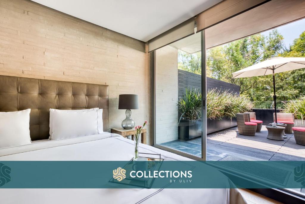 a bedroom with a bed and a patio with an umbrella at AR 218 Hotel by ULIV in Mexico City