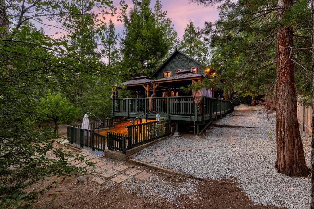 a house with a wrap around porch in the woods at Peaceful Cabin in Idyllwild