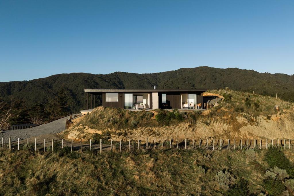 a house on top of a hill at The Hide Kapiti Accommodation in Paraparaumu