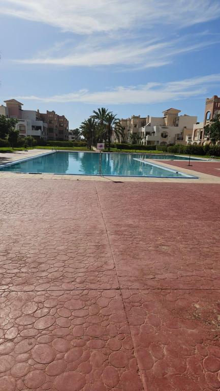 an empty swimming pool in the middle of a building at Villa lux AP2 in Saïdia