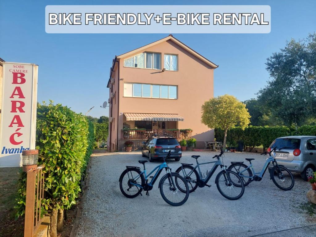 three bikes parked in a parking lot in front of a building at Pansion Ivanka Barac in Međugorje