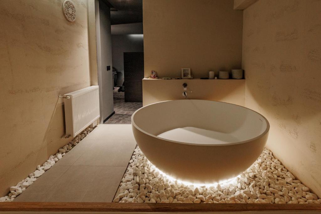 a bathtub with lights on the floor of a bathroom at Hedonist SPA in Jagodina
