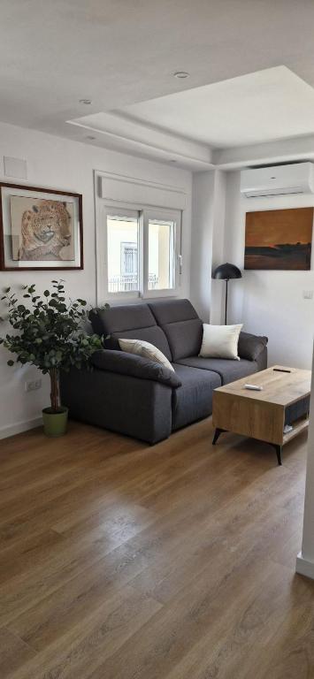a living room with a couch and a table at Espectaculares Aptos Castillo de Bellver in Camas