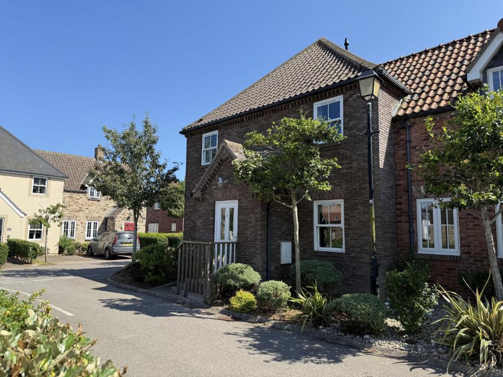 a brick house with a car parked in a driveway at 12 Green Close at The Bay Filey, sleeps 8, 2 dogs welcome for free too in Filey