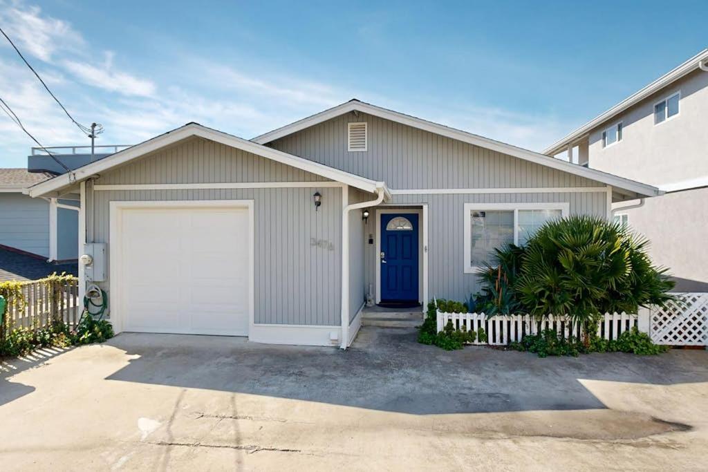a house with a blue door and a garage at Blue Door Retreat in Cayucos