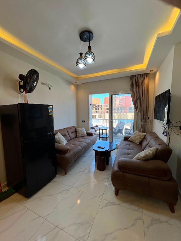 a living room with two couches and a tv at عماره 227 in El Alamein