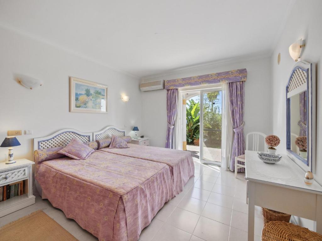 a bedroom with a bed and a window at Casa Trajlon in Praia do Carvoeiro