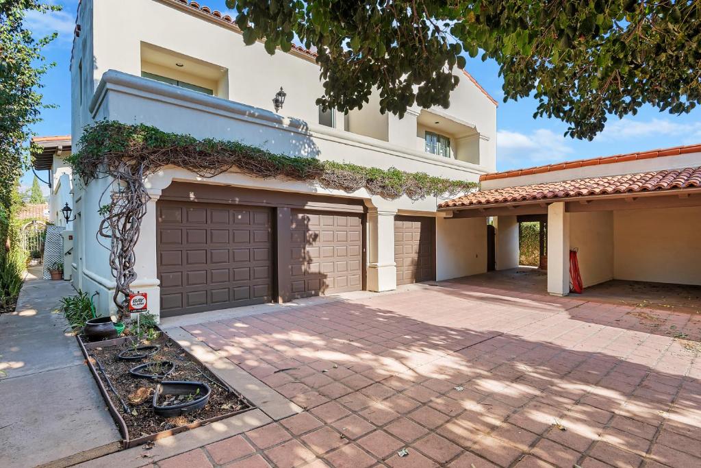 a house with two garage doors and a driveway at Garden Escape in Santa Barbara
