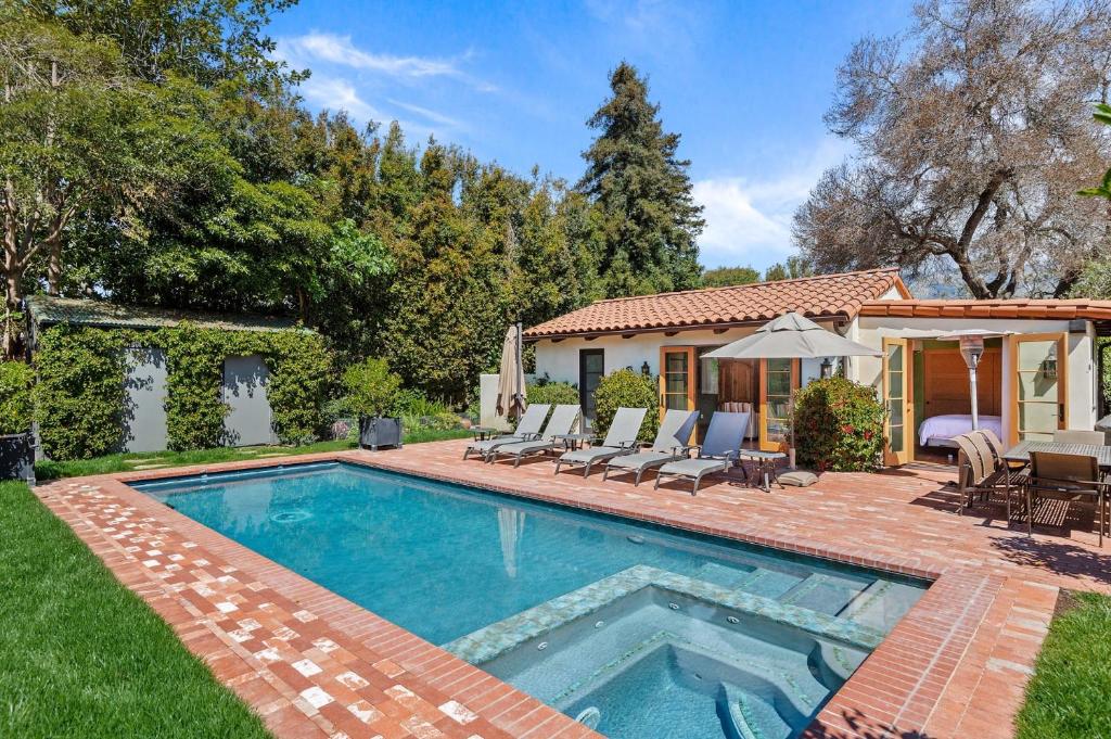 a swimming pool in the yard of a house at Casa Alegria in Santa Barbara