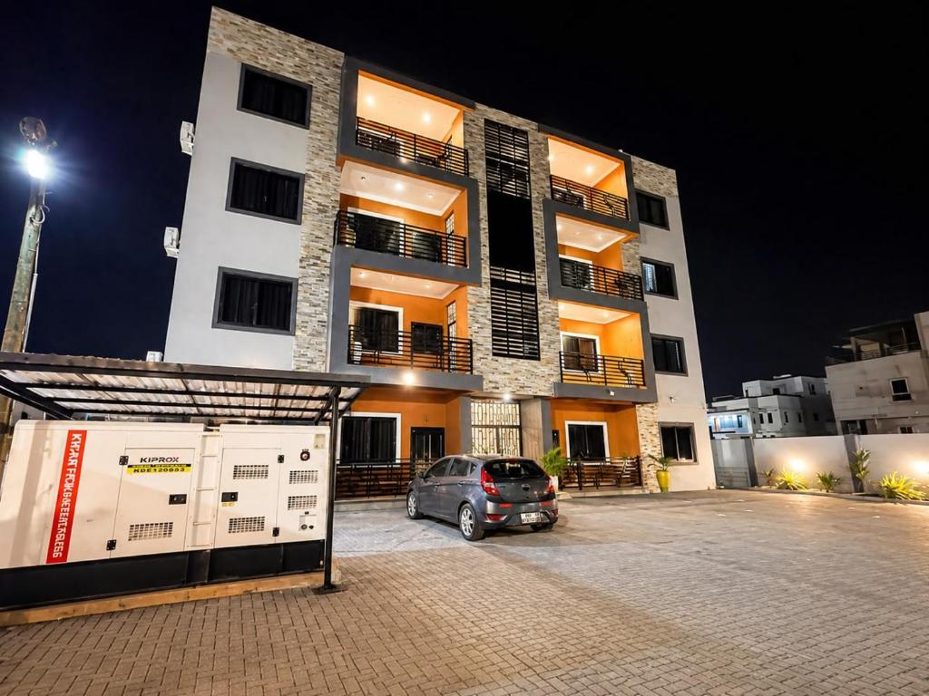 a car parked in a parking lot in front of a building at Naso Luxe Homes in Sakumona