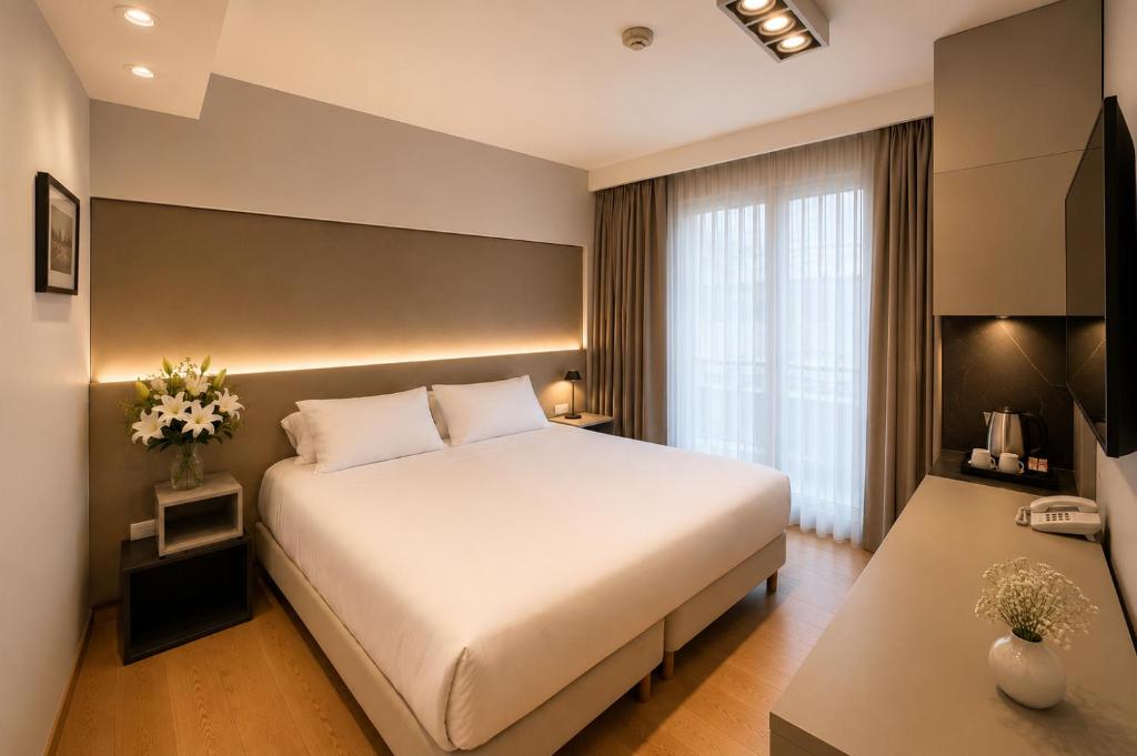 a bedroom with a large white bed and a window at Purobaires Hotel Boutique in Buenos Aires
