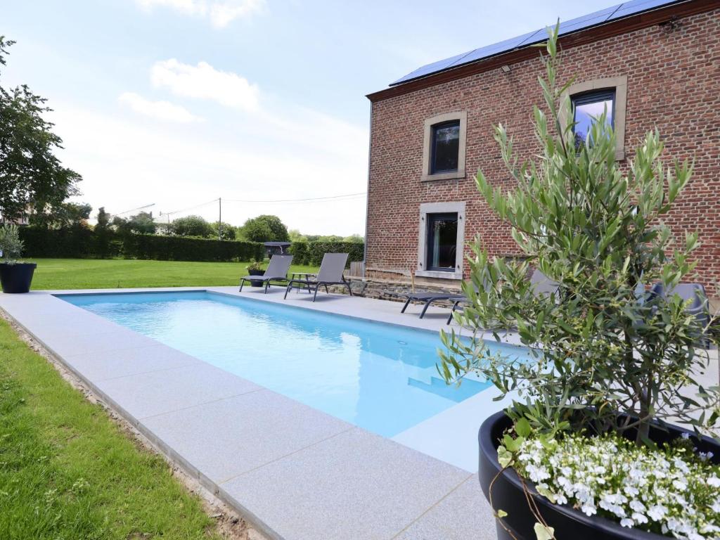 a swimming pool in the backyard of a house at Relais de Zoé in Gesves
