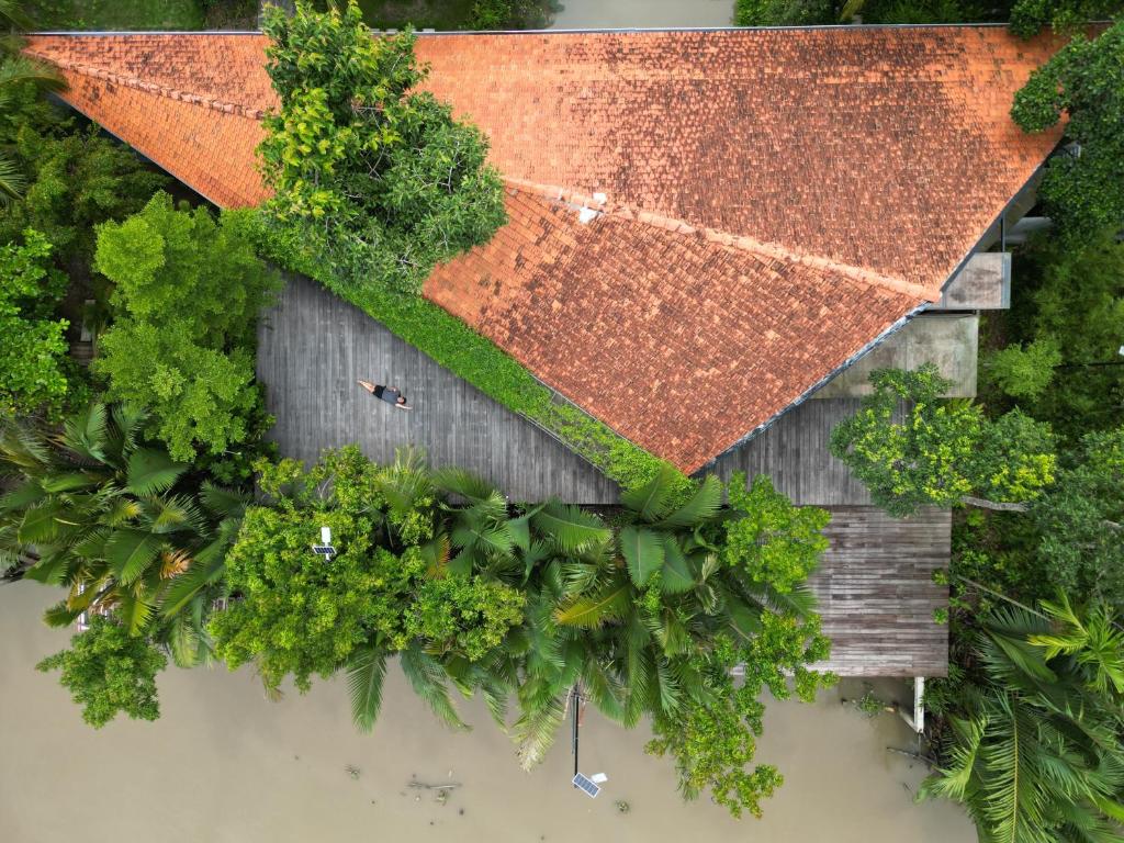 an overhead view of a building with a rusty roof at Haven Nest Retreat in Ấp Phú Hòa (3)