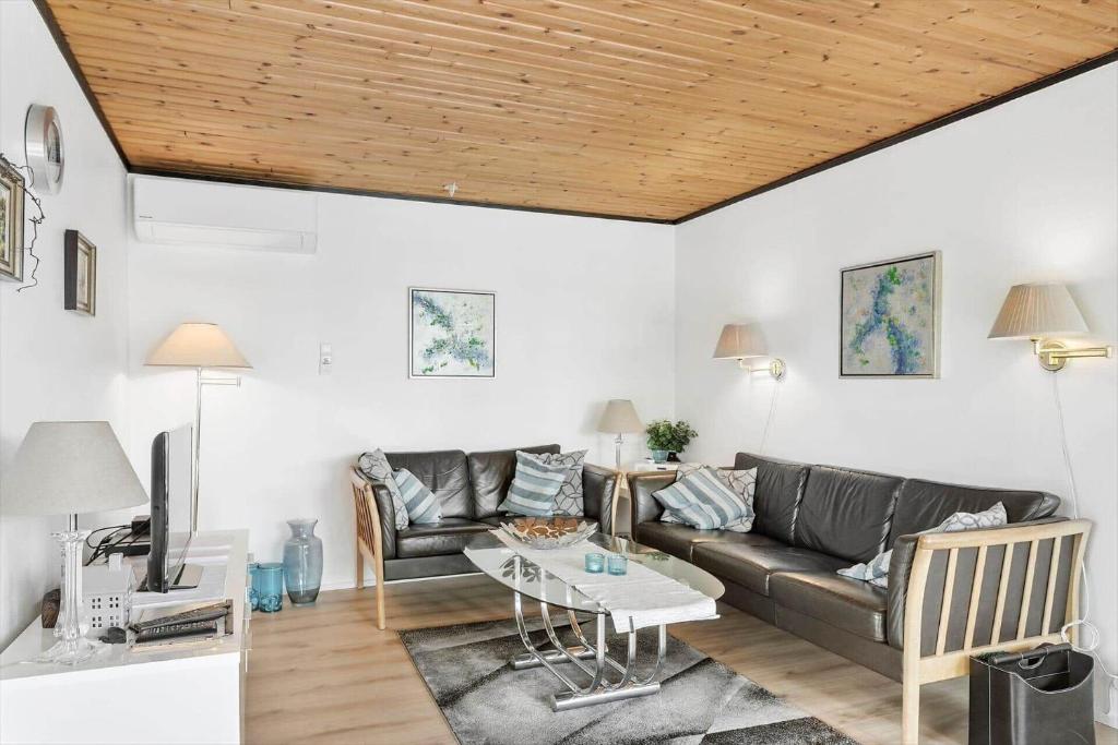 a living room with a couch and a table at 7041-Bogo-By-Tarnbakken-21 in Bogø By
